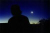 Night shot, long exposure with a friend in the foreground and the first quarter moon in the background